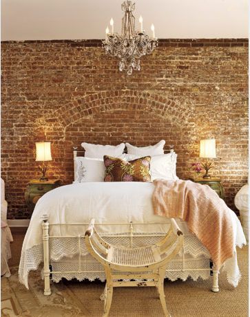 Shabby chic Bedroom with Brick accent wall, crystal chandelier, vintage bedding