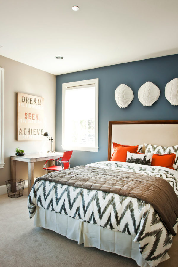 Blue grey bedroom accent wall with contrast colored art