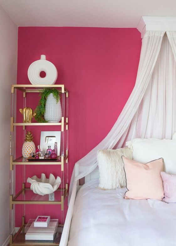 Bright pink girly accent wall in a bedroom