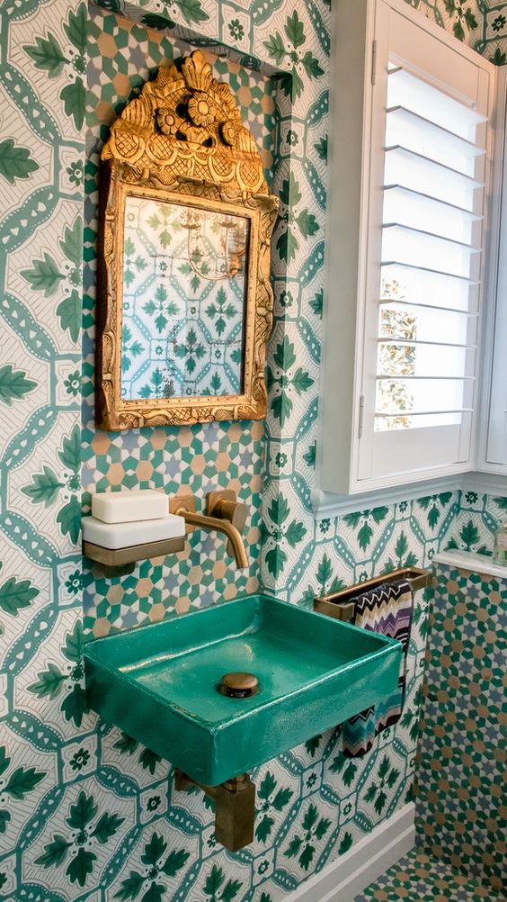 Eclectic bathroom with Moroccan tiles,French Antique mirror, handmade Spanish ceramic basin, green and white wallpapers