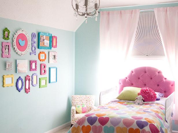 Pretty blue and pink girls bedroom with a gallery wall decoration