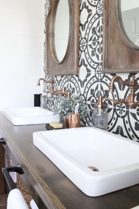 Vintage bathroom with ethnic pattern tiles and wooden vanity and mirror frames