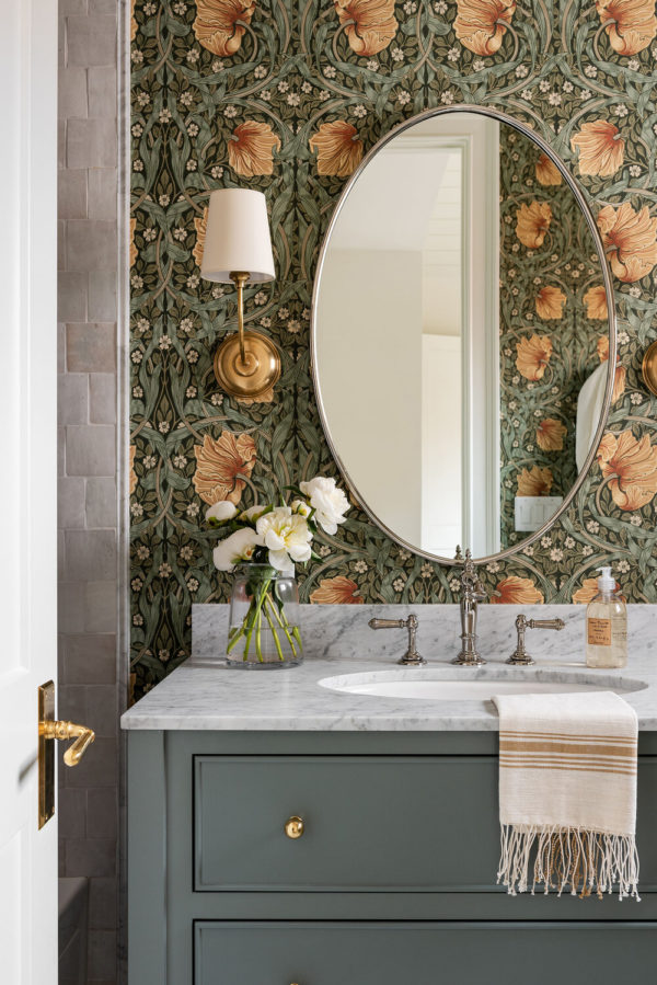Elegant bathroom with floral wallpapers , marble vanity top and backsplash