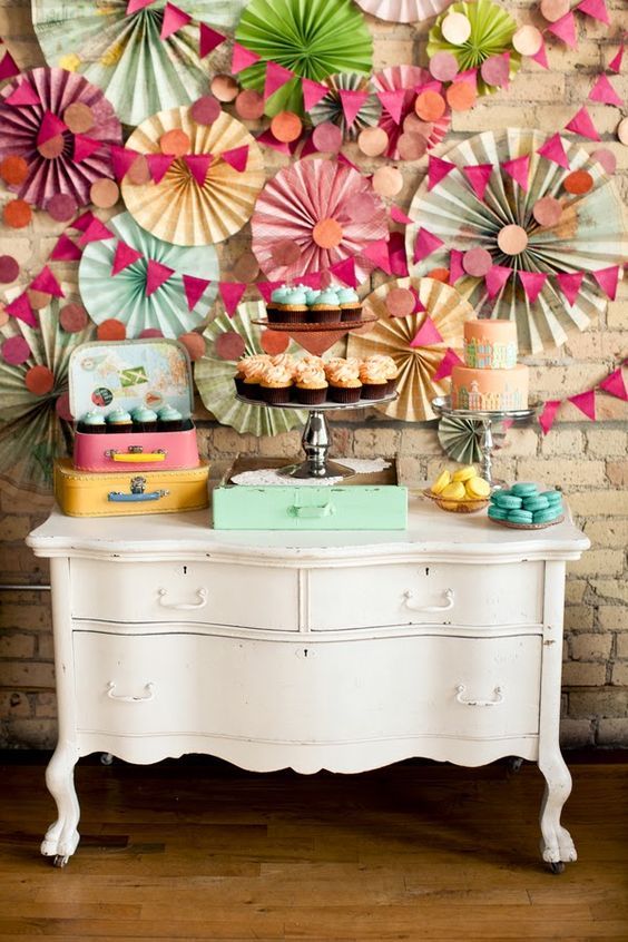 Paper fans and garlands backdrop party decor