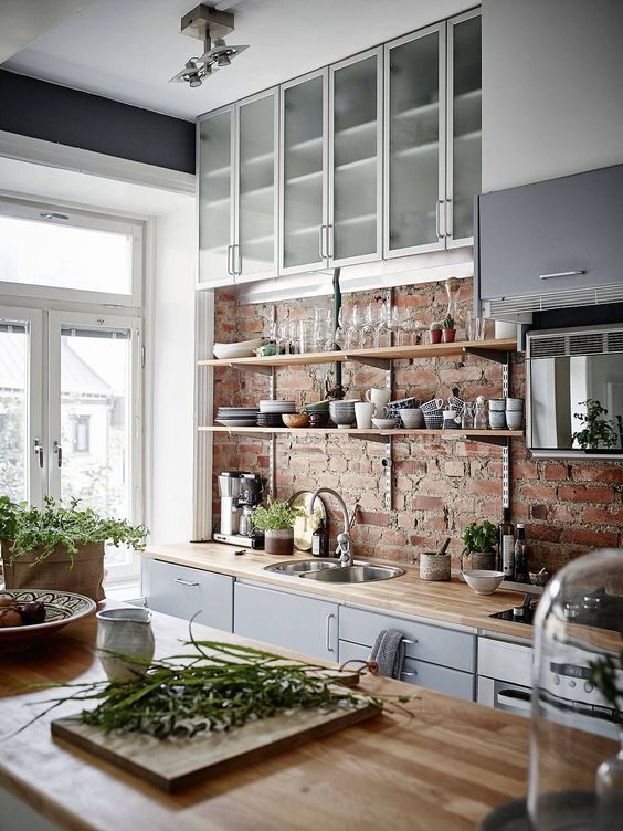 white and grey kitchen with red brick backsplash